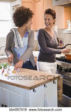 Mixed race mother and daughter cooking in kitchen View Large Photo Image Stock Photograph - Mixed race mother and daughter cooking in kitchen. Fotosearch
