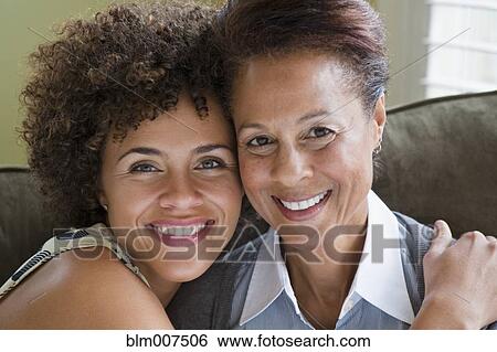 Mixed race mother and daughter hugging View Large Photo Image Stock Photograph - Mixed race mother and daughter hugging. Fotosearch