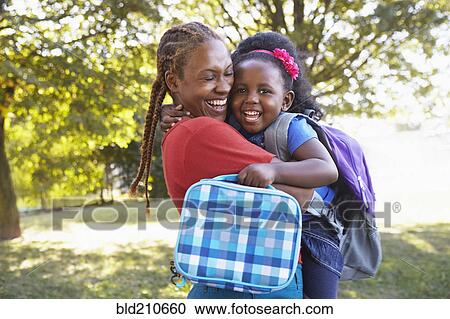 Mixed race mother and hugging daughter View Large Photo Image Stock Image - Mixed race mother and hugging daughter. Fotosearch