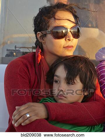 Stock Photo - Mixed race mother hugging son. Fotosearch