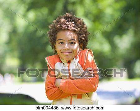 Stock Photograph - Mixed race outdoors with arms crossed. Fotosearch