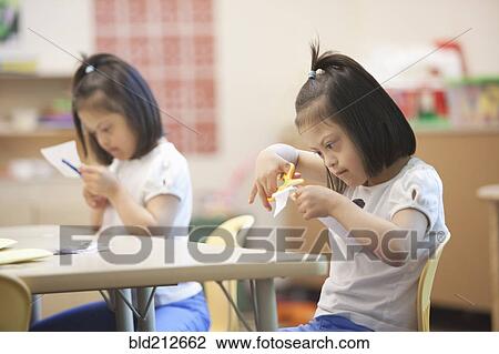 Mixed race students with Down syndrome in classroom View Large Photo Image Stock Image - Mixed race students with Down syndrome in classroom. Fotosearch