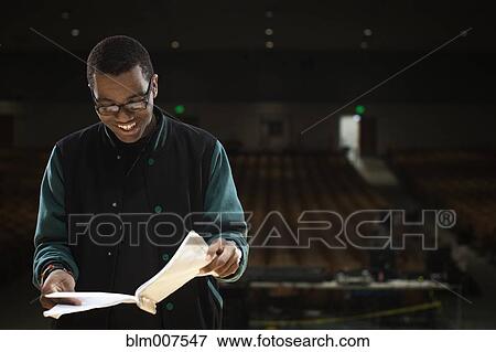 Mixed race teenage boy rehearsing on stage View Large Photo Image Stock Photo - Mixed race teenage boy rehearsing on stage. Fotosearch