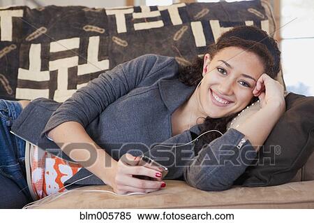 Stock Photography - Mixed race teenager listening to mp3 player. Fotosearch