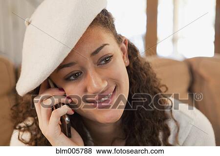 Stock Photo - Mixed race teenager talking on cell phone. Fotosearch