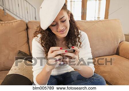 Mixed race teenager text messaging on cell phone View Large Photo Image Stock Photo - Mixed race teenager text messaging on cell phone. Fotosearch