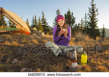Stock Photography - Mixed race woman camping. Fotosearch