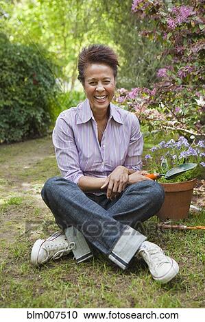 Mixed race woman gardening View Large Photo Image Stock Image - Mixed race woman gardening. Fotosearch