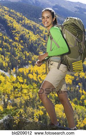 Stock Image - Mixed race woman hiking in mountains. Fotosearch