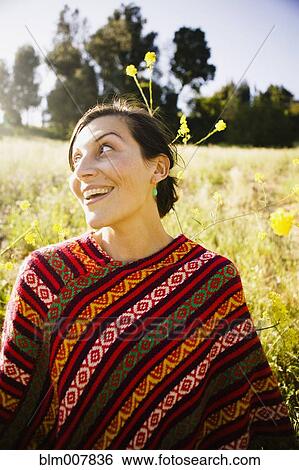 Stock Photograph - Mixed race woman in field. Fotosearch