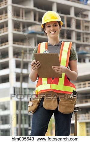 Mixed race woman in hard-hat on construction site View Large Photo Image Stock Image - Mixed race woman in hard-hat on construction site. Fotosearch