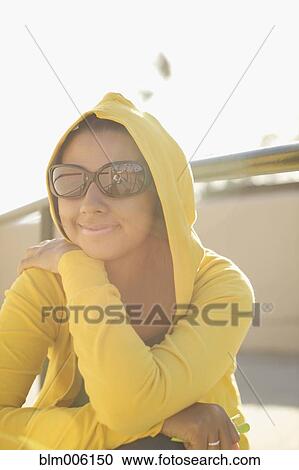 Mixed race woman in sunglasses and hoody View Large Photo Image Stock Image - Mixed race woman in sunglasses and hoody. Fotosearch