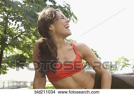 Picture - Mixed race woman laughing outdoors. Fotosearch