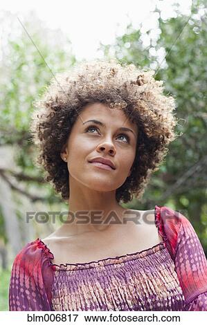 Stock Photo - Mixed race woman looking up. Fotosearch