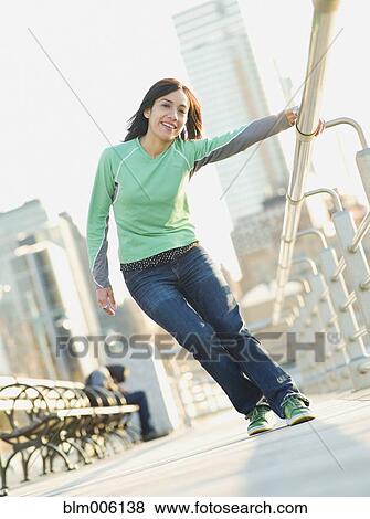 Mixed race woman on pier holding railing View Large Photo Image Stock Photo - Mixed race woman on pier holding railing. Fotosearch