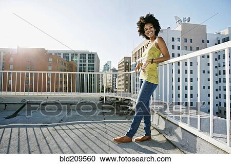 Mixed race woman on urban rooftop View Large Photo Image Stock Image - Mixed race woman on urban rooftop. Fotosearch