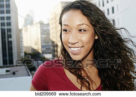Mixed race woman on urban rooftop View Large Photo Image Stock Photo - Mixed race woman on urban rooftop. Fotosearch