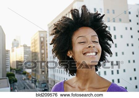 Mixed race woman on urban rooftop View Large Photo Image Stock Photograph - Mixed race woman on urban rooftop. Fotosearch