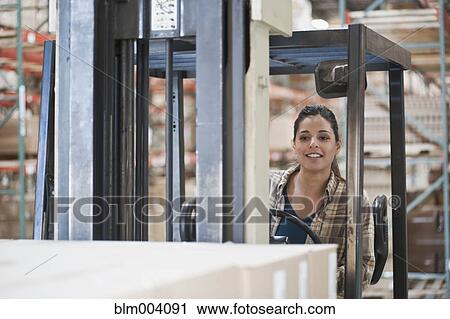 Mixed race woman operating forklift in warehouse View Large Photo Image Stock Image - Mixed race woman operating forklift in warehouse. Fotosearch