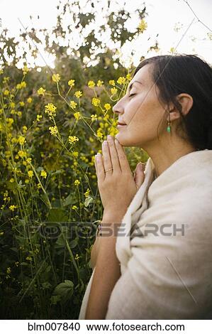 Mixed race woman praying with eyes closed in field View Large Photo Image Stock Image - Mixed race woman praying with eyes closed in field. Fotosearch
