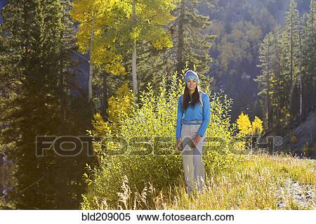Stock Photography - Mixed race woman smiling in woods. Fotosearch