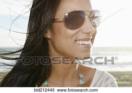 Mixed race woman smiling on beach View Large Photo Image Stock Photography - Mixed race woman smiling on beach. Fotosearch