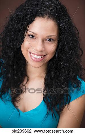 Stock Image - Mixed race woman smiling. Fotosearch