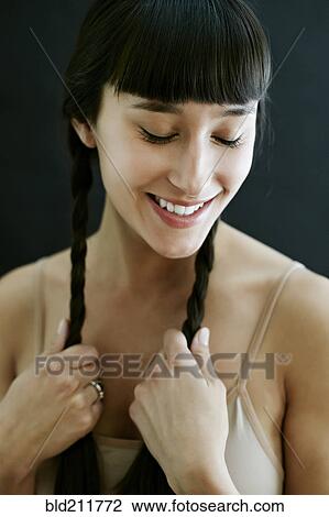 Stock Image - Mixed race woman smiling. Fotosearch