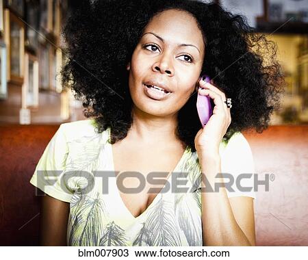 Mixed race woman talking on cell phone View Large Photo Image Stock Image - Mixed race woman talking on cell phone. Fotosearch