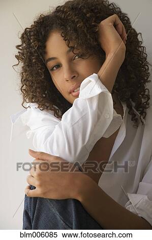 Stock Photography - Mixed race woman thinking. Fotosearch