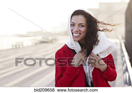 Stock Photo - Mixed race woman walking on pier. Fotosearch