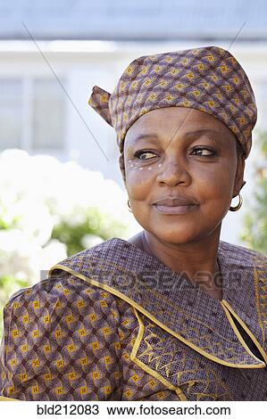 Stock Image - Mixed race woman wearing traditional clothing. Fotosearch