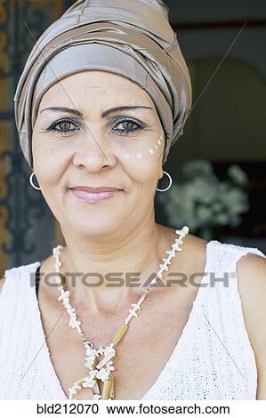 Stock Image - Mixed race woman wearing turban. Fotosearch