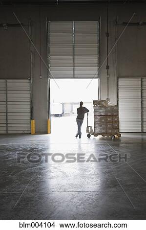 Mixed race woman with cardboard boxes on pallet at loading dock View Large Photo Image Picture - Mixed race woman with cardboard boxes on pallet at loading dock. Fotosearch