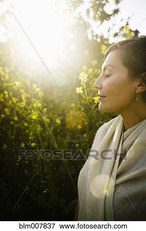 Mixed race woman with eyes closed in field View Large Photo Image Stock Photo - Mixed race woman with eyes closed in field. Fotosearch