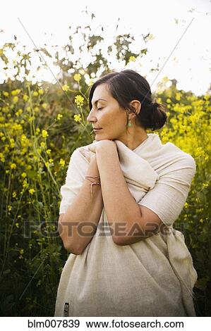 Mixed race woman with eyes closed in field View Large Photo Image Stock Photo - Mixed race woman with eyes closed in field. Fotosearch