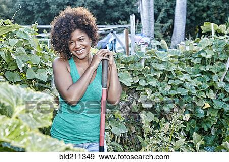 Mixed race woman working in garden View Large Photo Image Stock Photo - Mixed race woman working in garden. Fotosearch