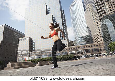 Mixed race woman working out on city street View Large Photo Image Stock Image - Mixed race woman working out on city street. Fotosearch