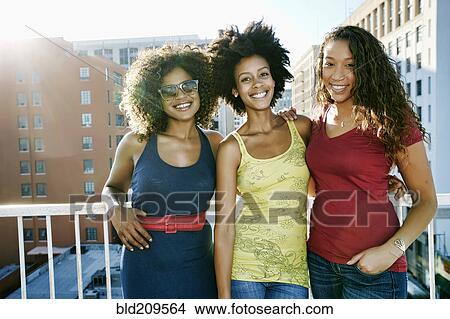 Mixed race women on urban rooftop View Large Photo Image Picture - Mixed race women on urban rooftop. Fotosearch