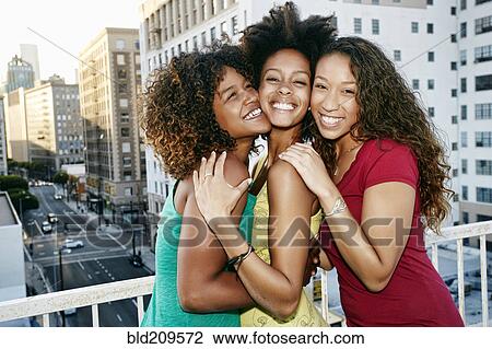 Mixed race women on urban rooftop View Large Photo Image Stock Image - Mixed race women on urban rooftop. Fotosearch