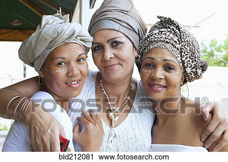 Stock Image - Mixed race women wearing turban. Fotosearch