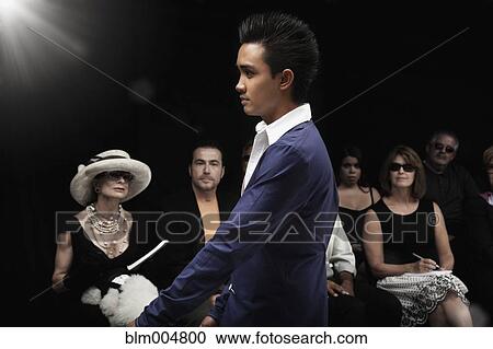 Stock Image - Model on runway in fashion show. Fotosearch