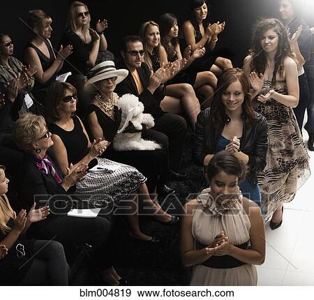 Stock Photo - Models clapping on runway at fashion show. Fotosearch