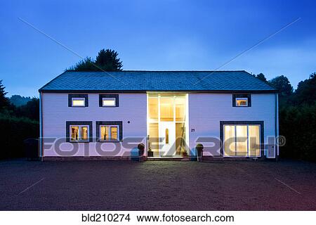 Picture - Modern house illuminated at twilight. Fotosearch
