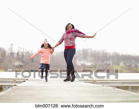 Mother and daughter enjoying walking outdoors View Large Photo Image Stock Photograph - Mother and daughter enjoying walking outdoors. Fotosearch