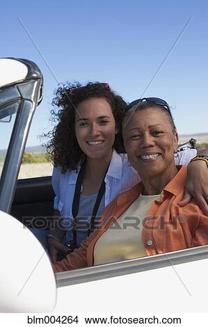 Mother and daughter hugging in convertible View Large Photo Image Picture - Mother and daughter hugging in convertible. Fotosearch