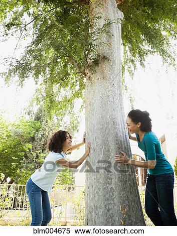 Stock Photography - Mother and daughter playing in park. Fotosearch
