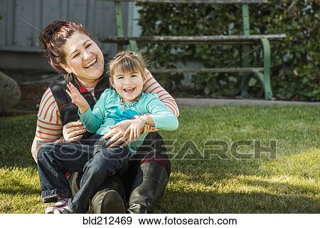 Mother and daughter smiling outdoors View Large Photo Image Stock Photo - Mother and daughter smiling outdoors. Fotosearch