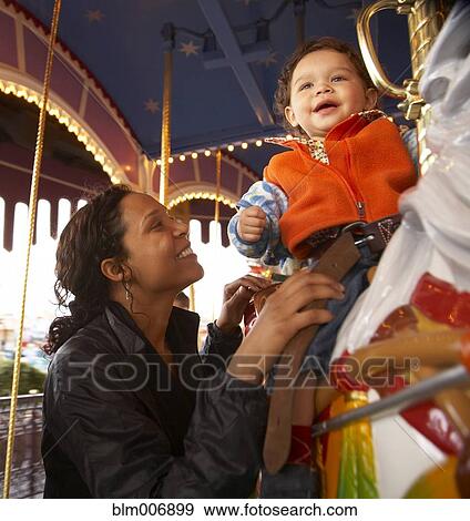 Mother and son enjoying carousel ride View Large Photo Image Stock Photo - Mother and son enjoying carousel ride. Fotosearch