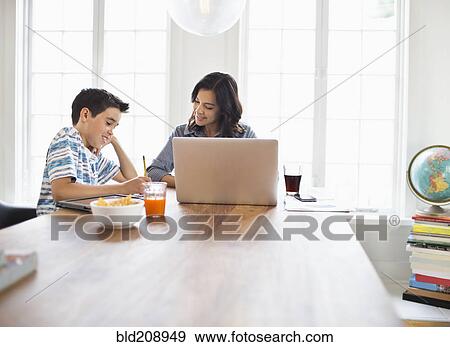 Stock Photo - Mother and son having breakfast together. Fotosearch